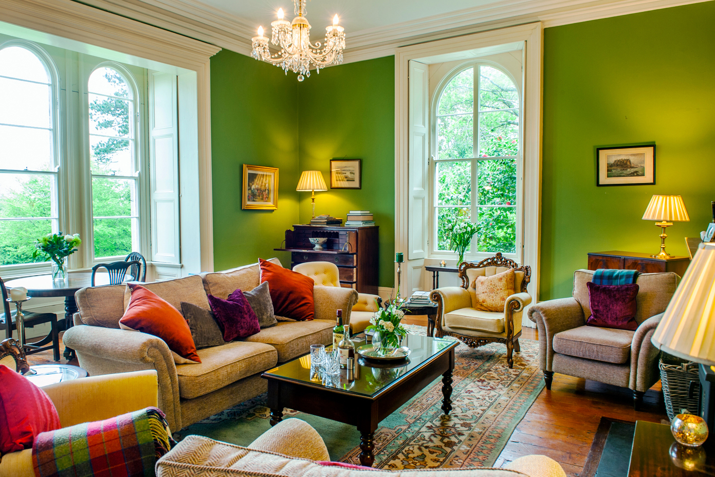 Coolclogher House - elegant green lounge with floor to ceiling arched windows