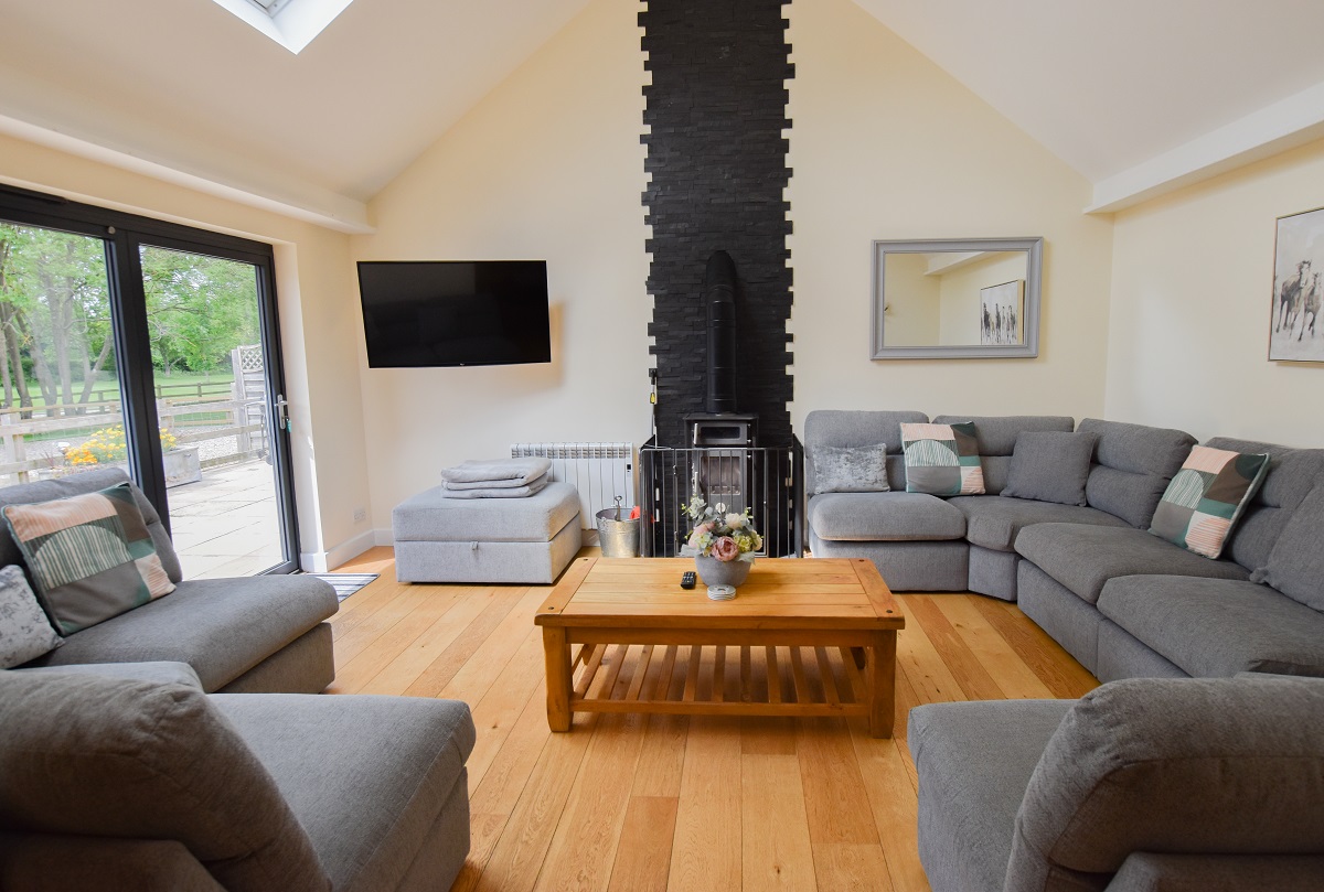 Cotswold Manor Stables - high vaulted sitting room with wood burning stove