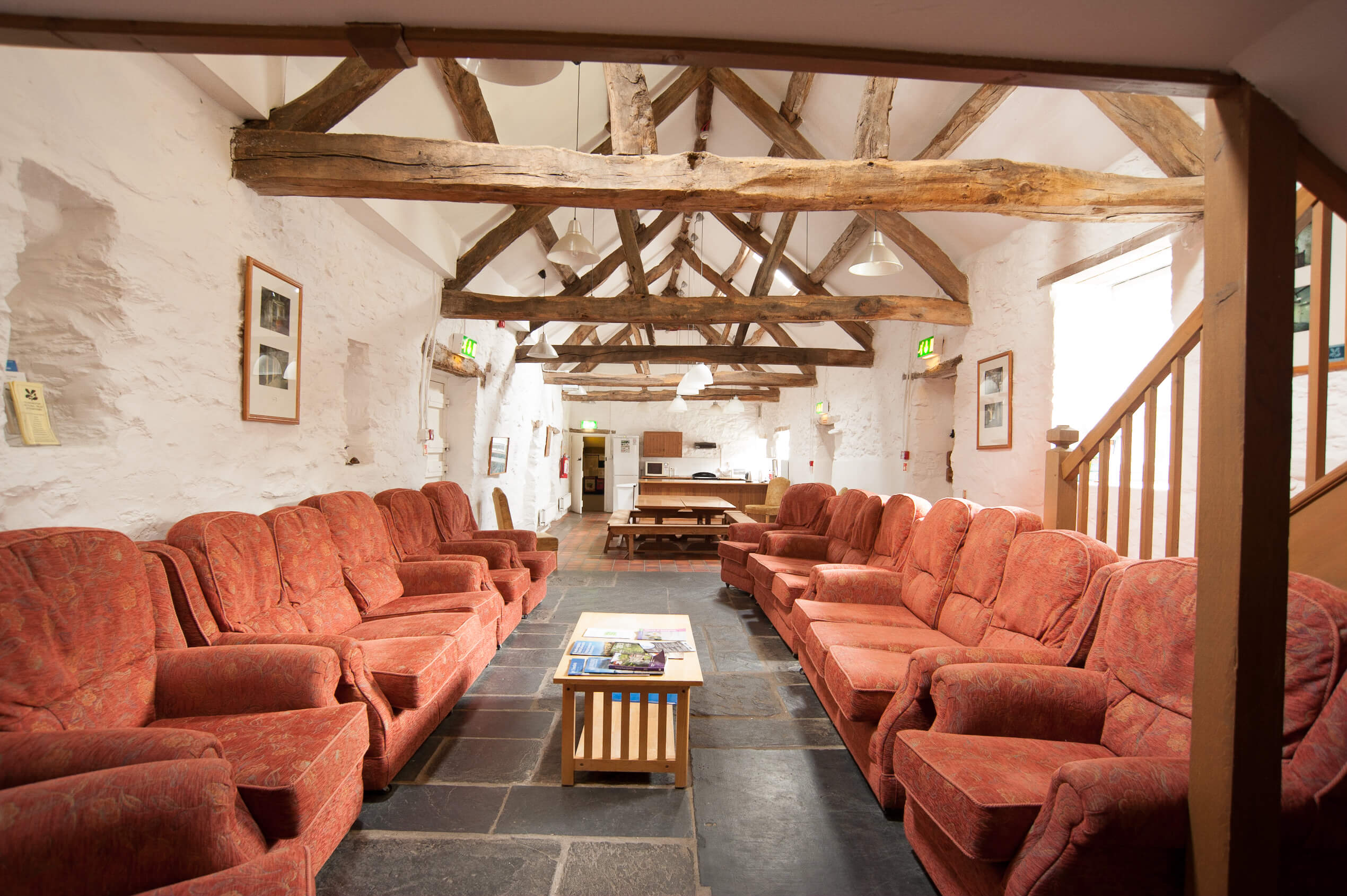 National Trust - Hendre Isaf Bunkhouse - large living room with plenty of sofas, open to the kitchen