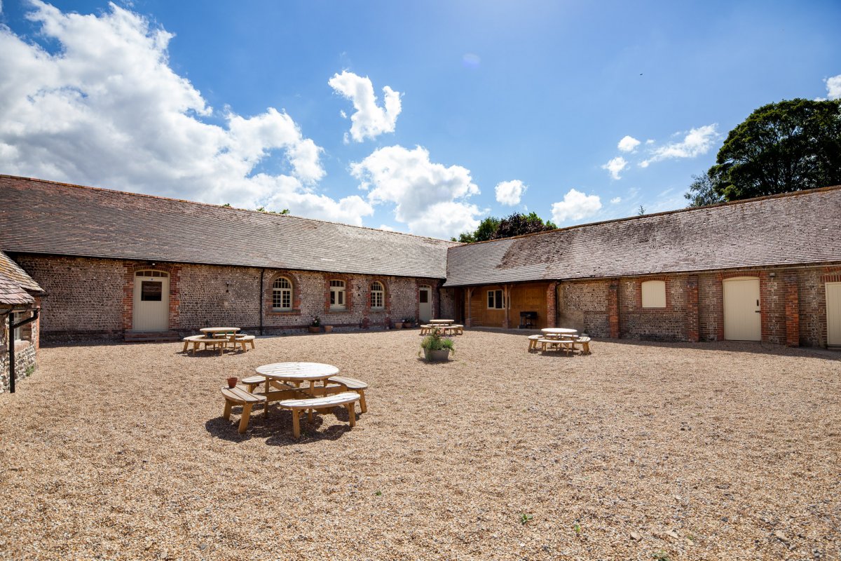 South Downs Bunkhouse - courtyard with fire pit and BBQ