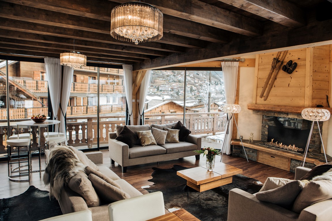 Chalet Ice - light filled lounge with comfy sofas, a fireplace and a pool table