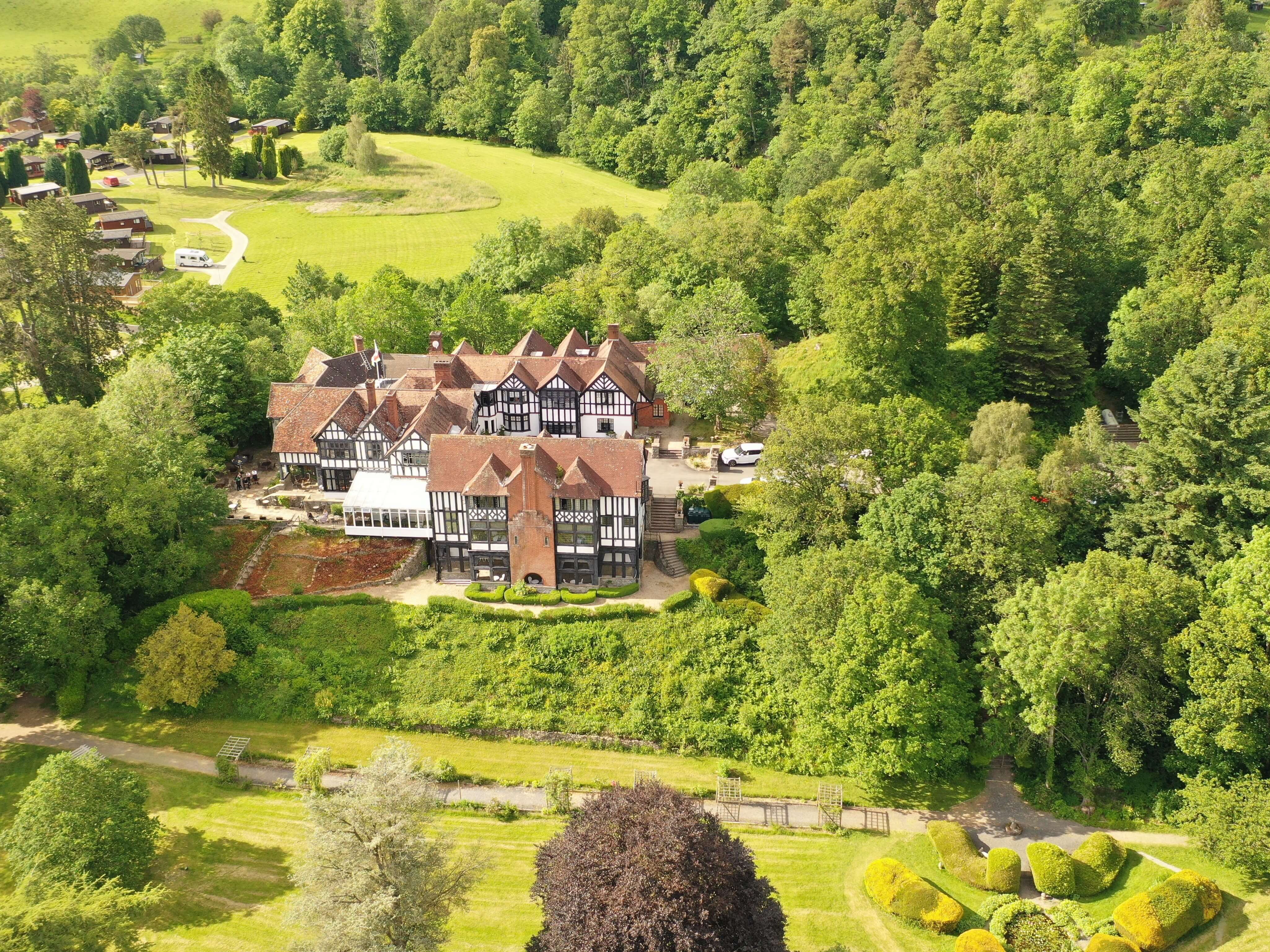Caer Beris Manor - an aerial view of the house woth pretty grounds and gardens for weddings