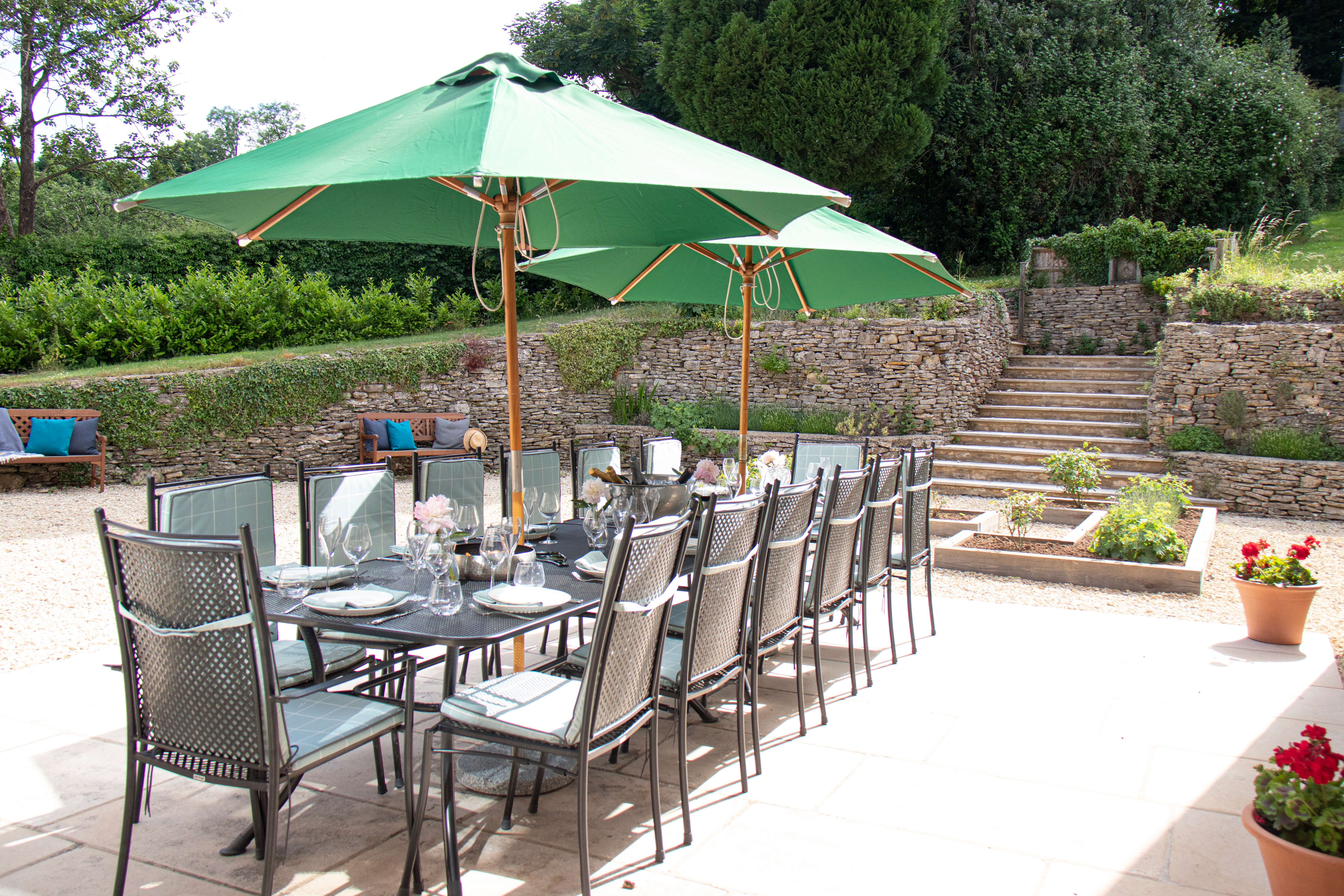 Woodchester Valley House - patio surrounded by pretty mature gardens