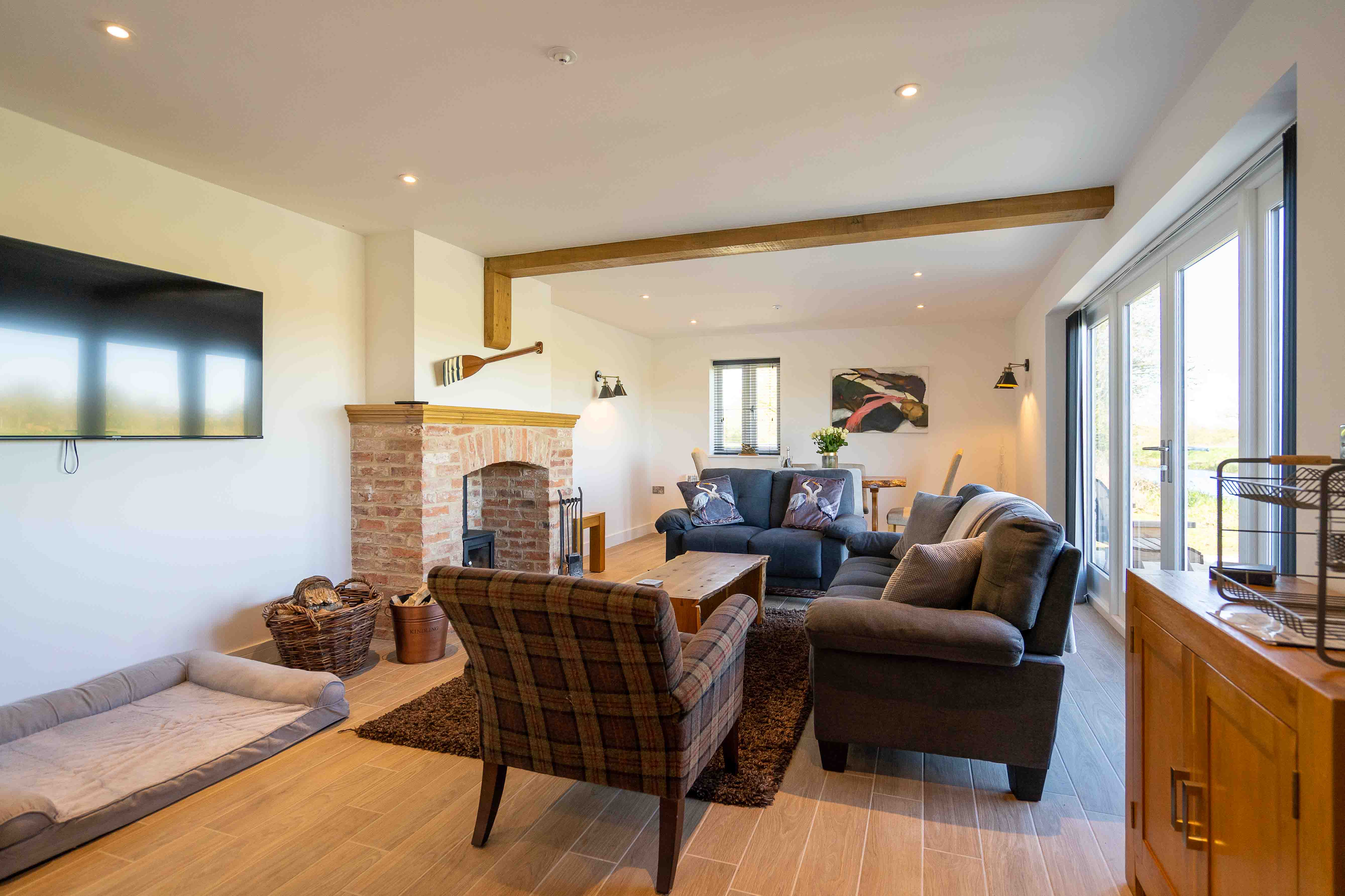 Fletland Holiday Hamlet, The Holt - lounge with wood stove and wall mounted TV