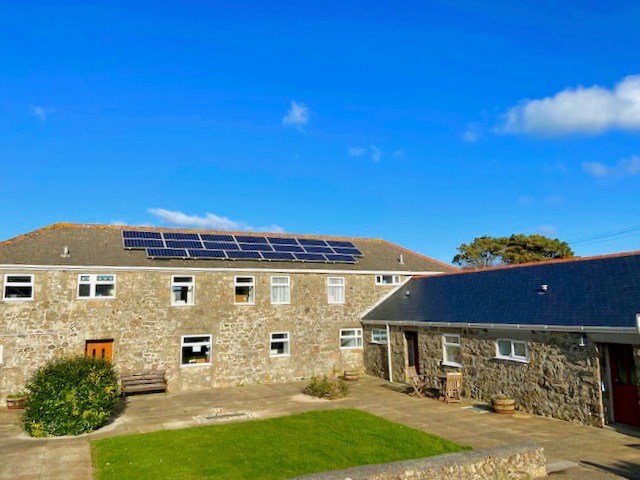 Trevalgan Farm Holidays - Carthouse, Lanhydrock and Stable look over a grassed courtyard