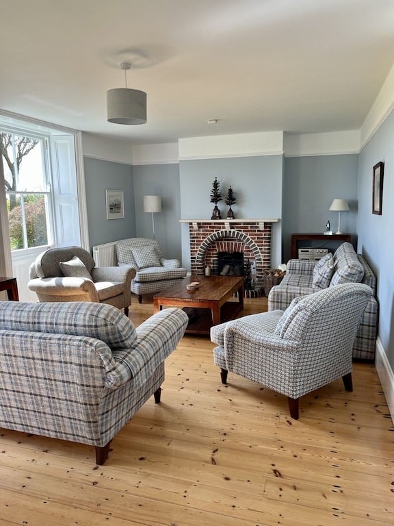 The Mill House IOW - elegant lounge with open fireplace