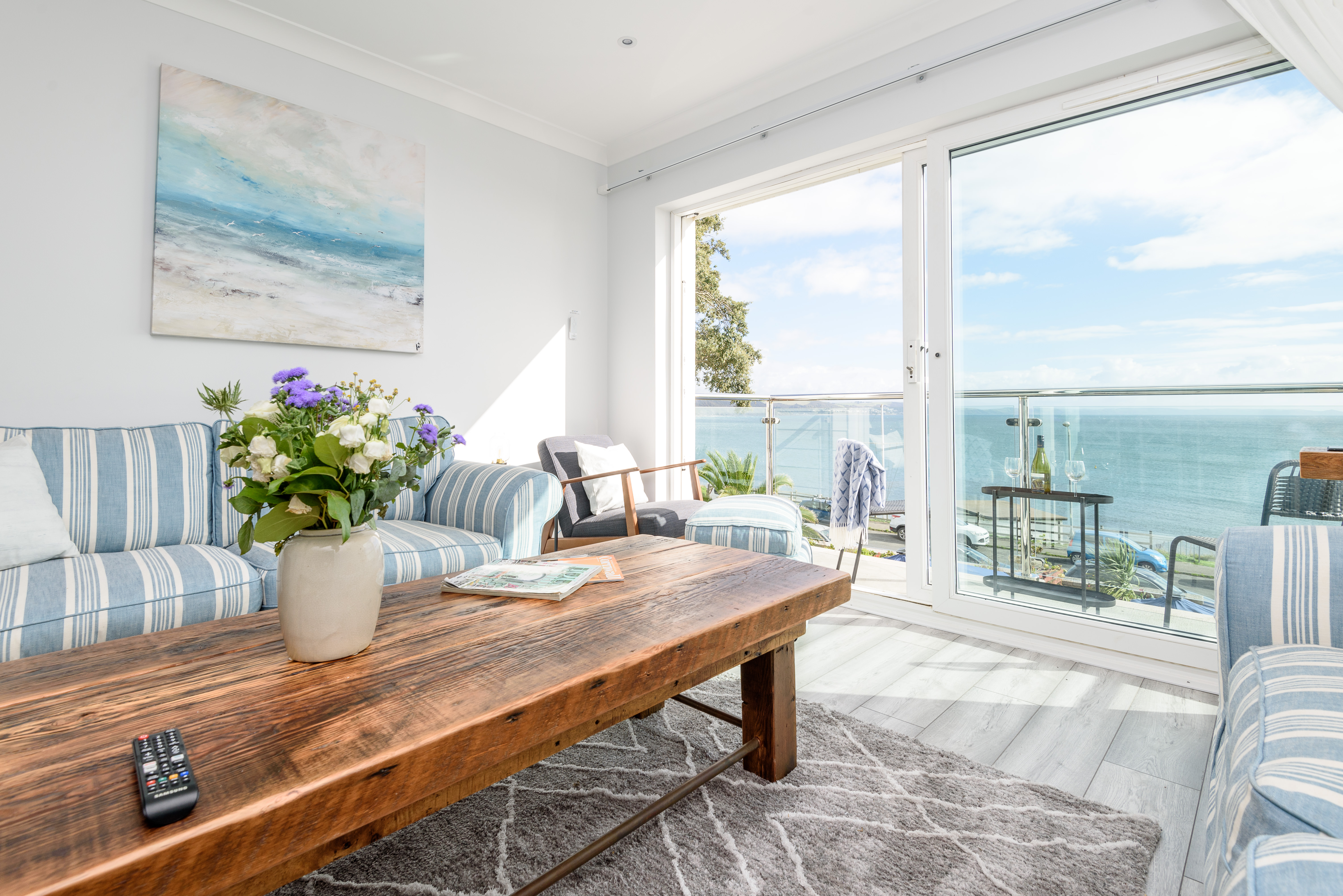 Beach House, Cornwall - comfortable lounge area with access to the balcony