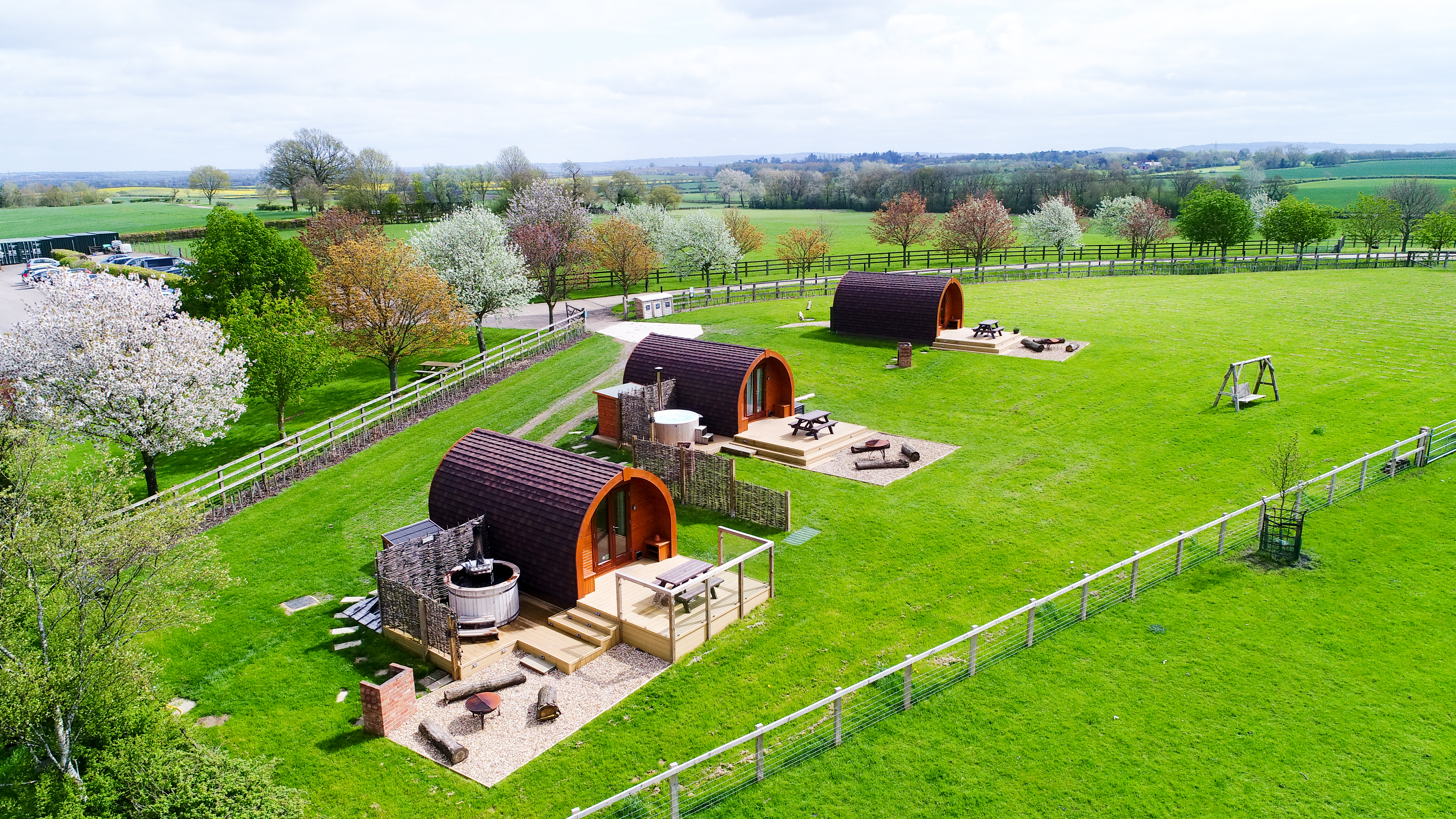 Wingbury Farm Glamping - aerial view of the 3 pods and outside decked areas