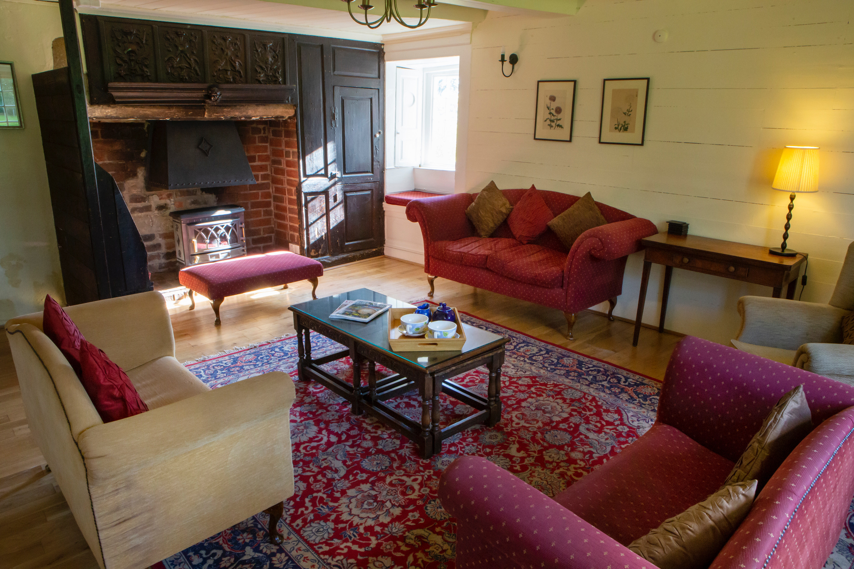Dunstan Hall - cosy up to the fireplace in this seating area