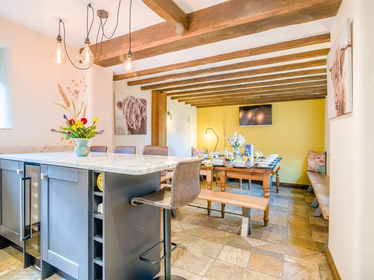 Old Dairy open plen kitchen and dining room with a large table seating 16