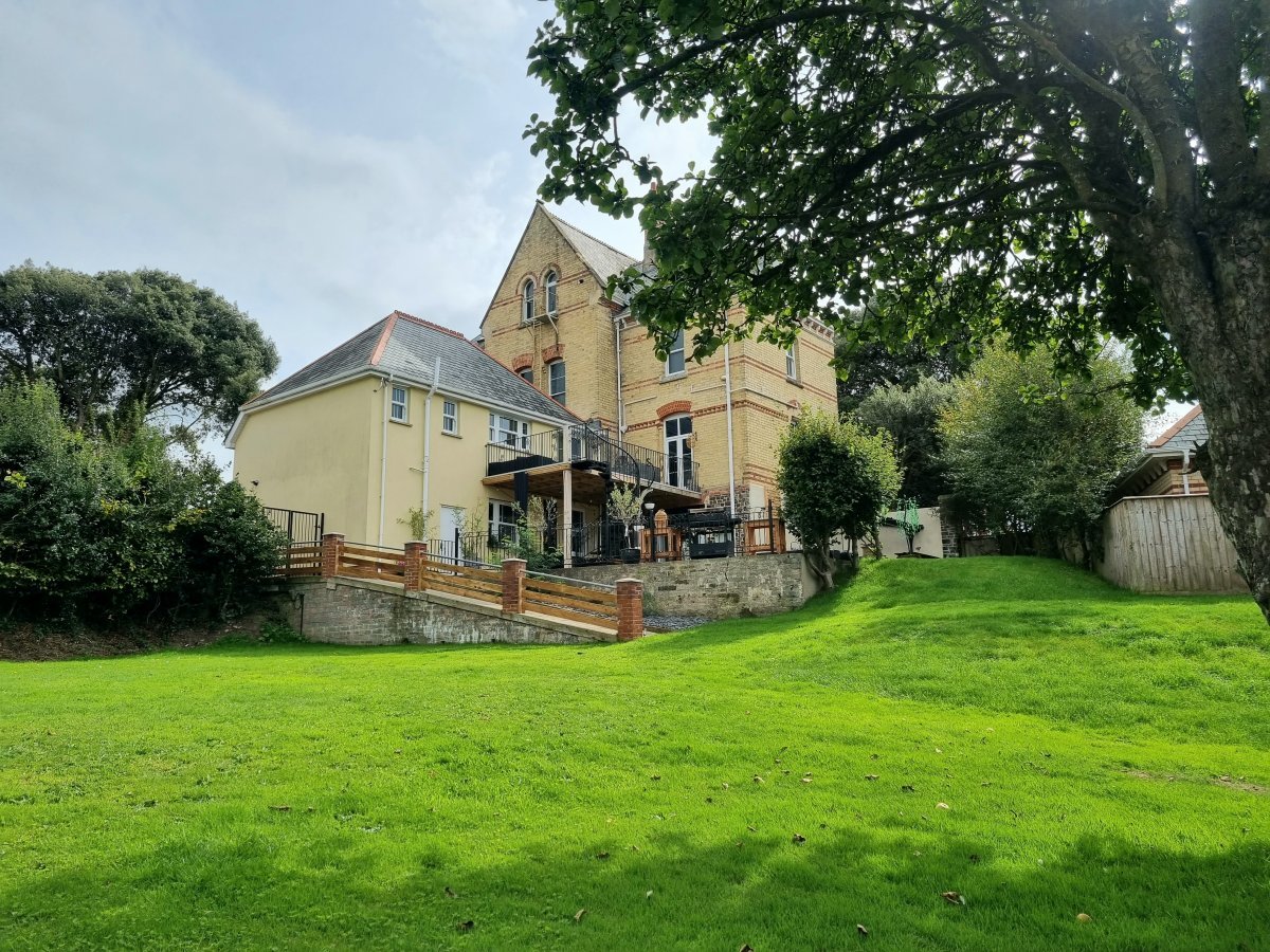 Cross Park House - rear aspect with balcony, enclosed patio and lawns