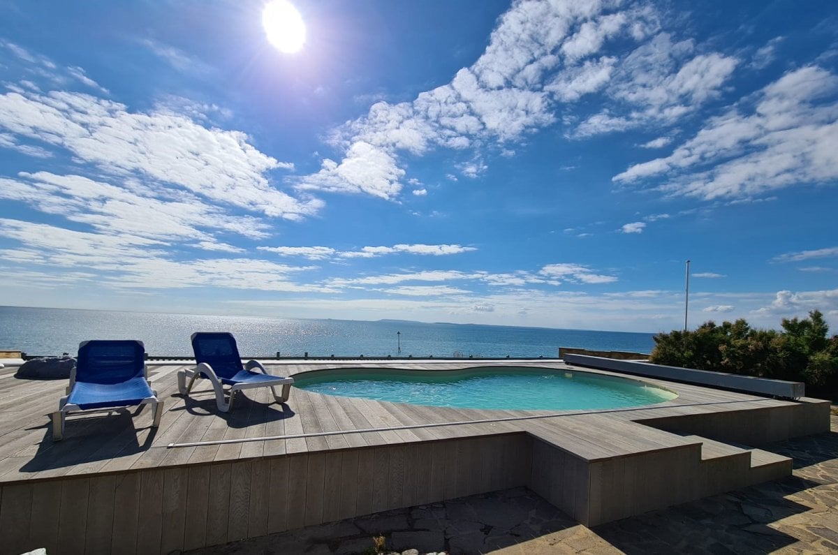 Lazing by the pool at Selsey Beach House