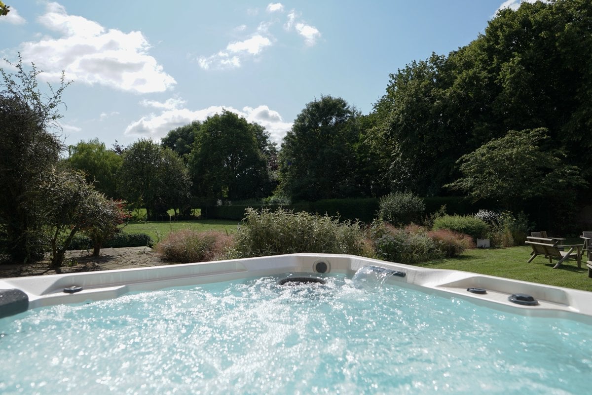 The hot tub has views over the garden