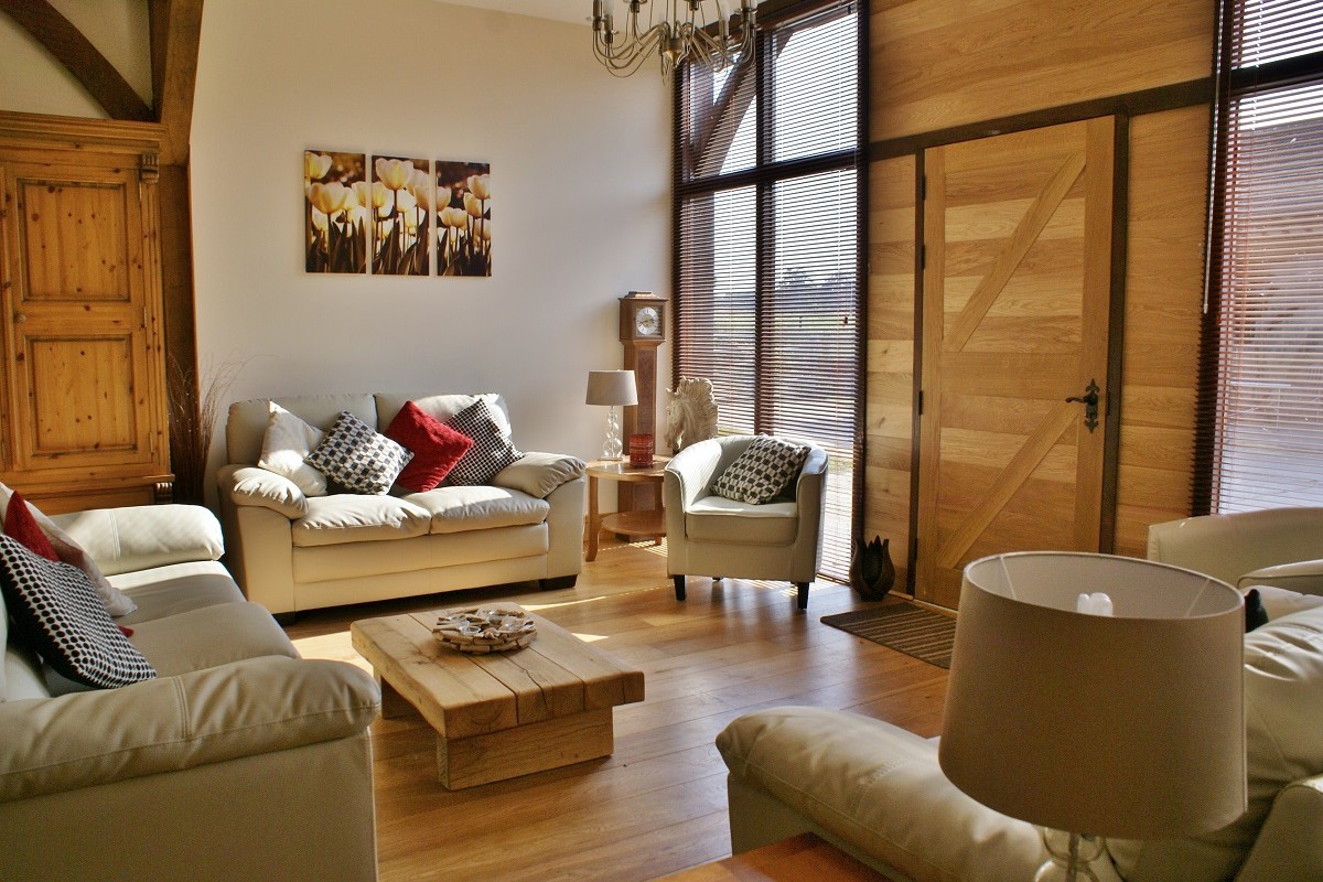 Vaulted sitting room with numerous sofas and chairs.