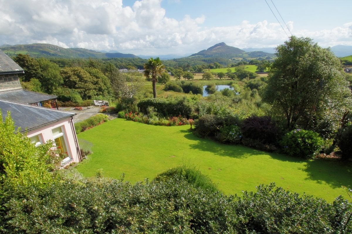 The house enjoys a stunning setting looking out over the valley to the mountains