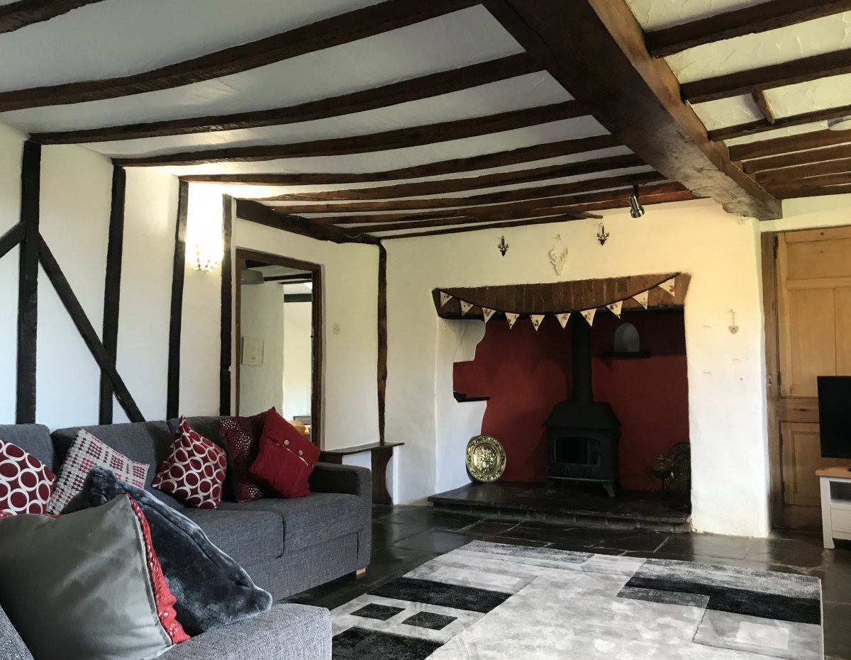 Main lounge in the Farmhouse - woodburner, slate floors.