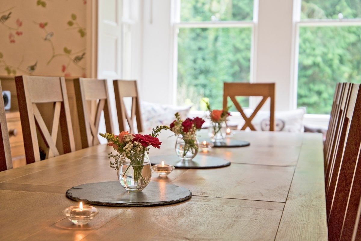 An elegant oak-panelled dining room seating 12 people