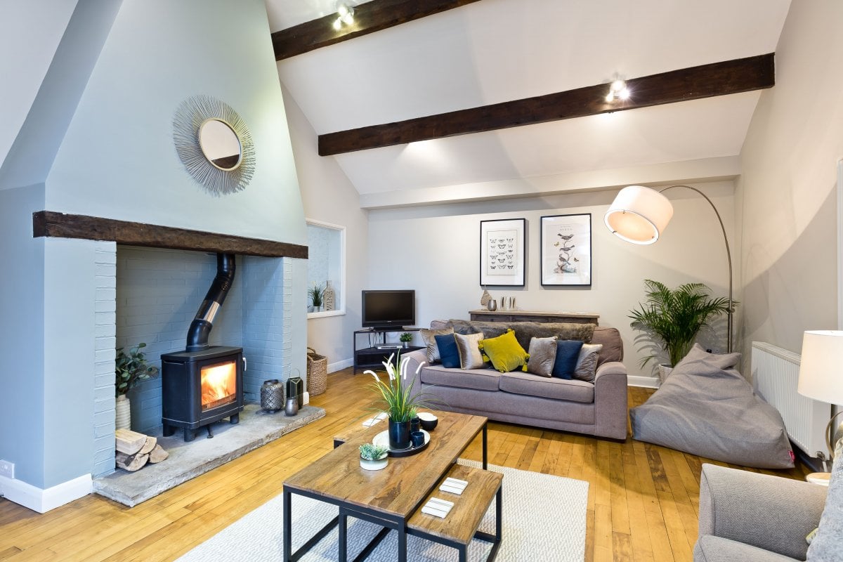 Large living room with log burner at Thornbridge Lodge
