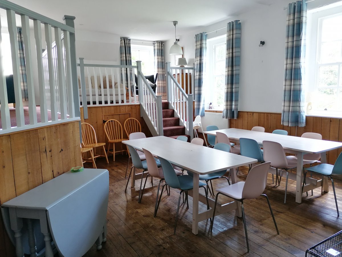 Dining room with seating for all guests around an open fire. Galleried seating area with sofas and desk space - ideal for WFH.