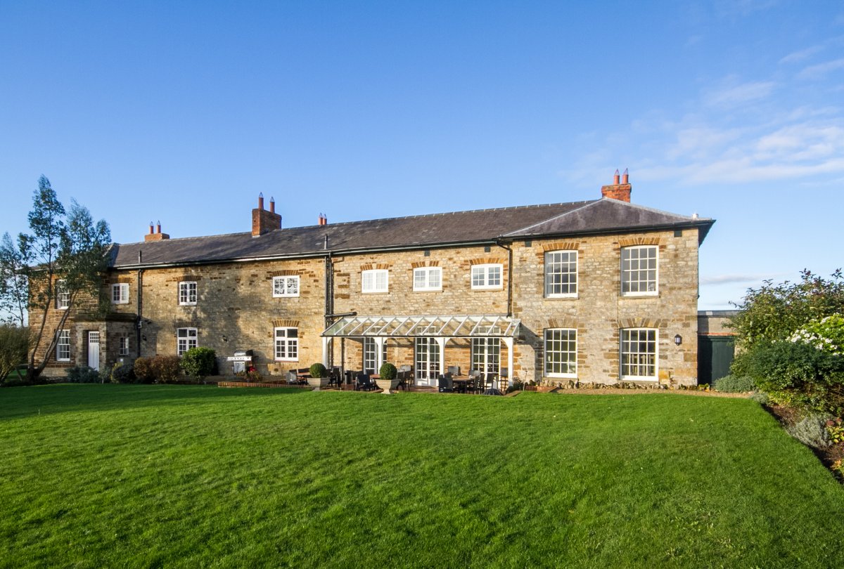 View of the house from the back lawn showing the terrace