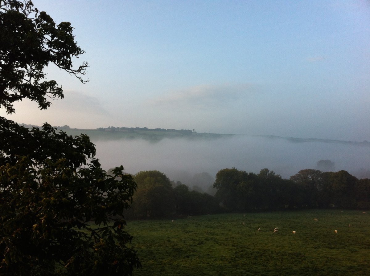 The early morning mist rising from River Lyd in the valley below