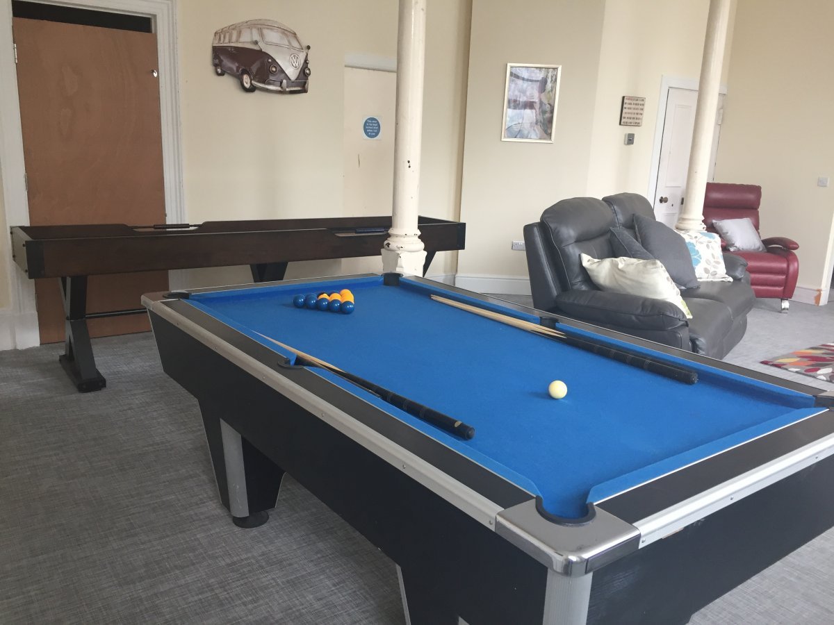 Games area with pool table, table football and shuffleboard table