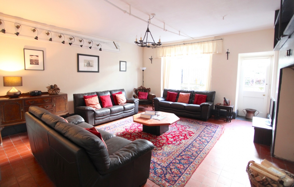 Old Bell House: Living room has lots of comfortable seating, view of private garden and a wood burner set in original slate inglenook fireplace