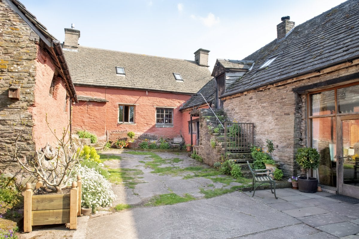 3 adjoining properties nestled round a yard