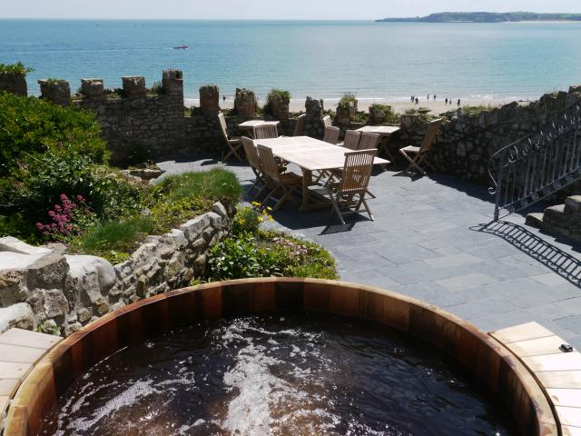 Cedar hot tub with a view to Caldey Island and out to sea.