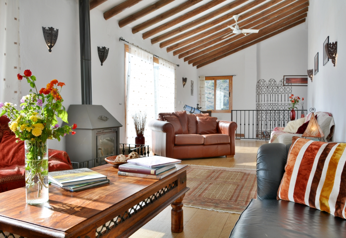 Spacious sitting room with large picture windows.