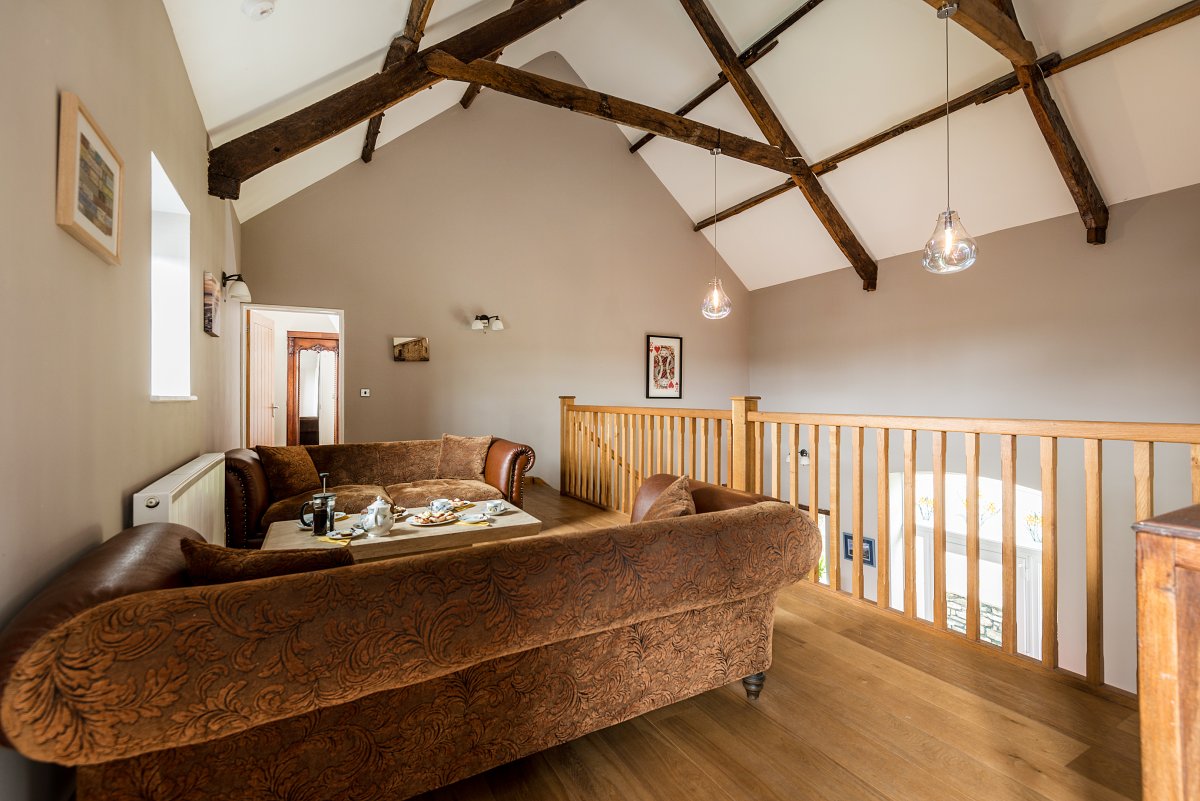 Kidwelly Farm Cottages - settees on the mezzanine balcony
