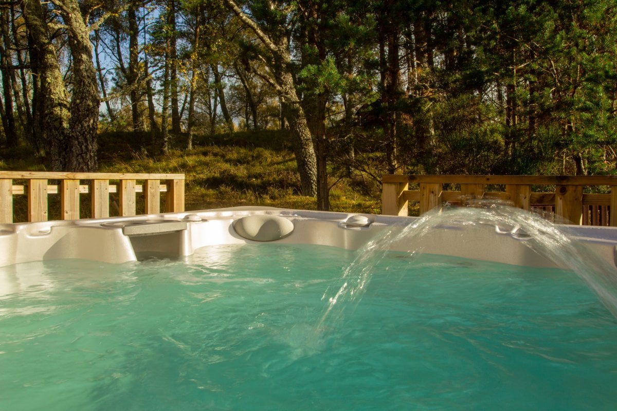Anderson lodge hot tub with woodland view