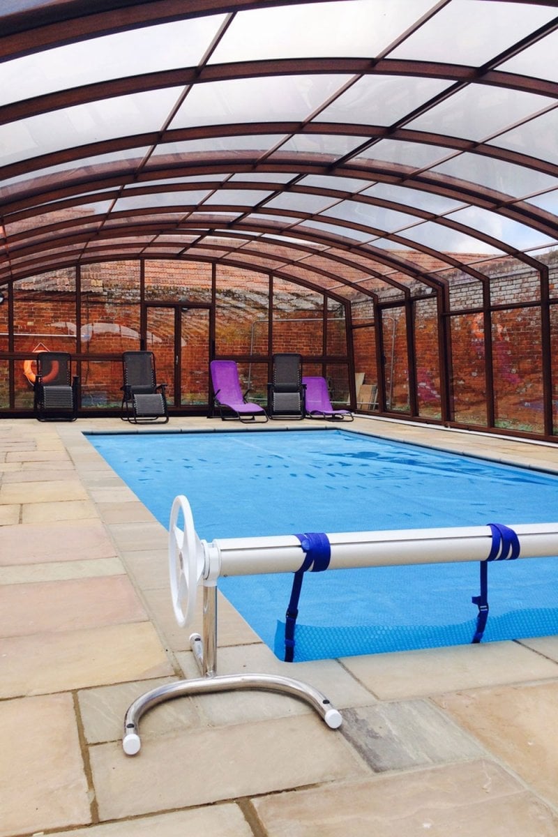 Heated pool within enclosure for all year round use