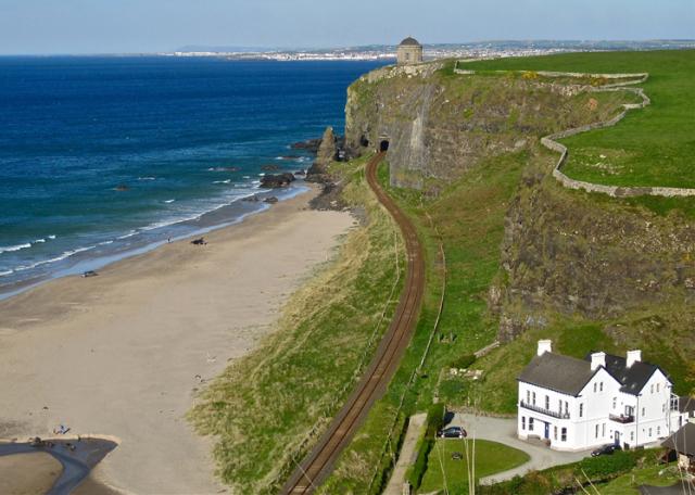 The house is nestled under the cliffs with uninterrupted sea views.