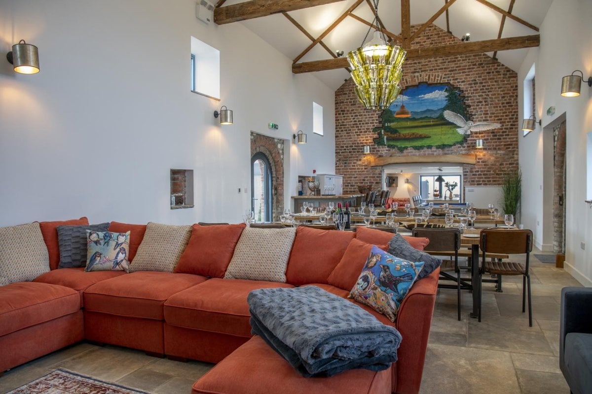 Open plan living and dinging room with original features including wooden beams and vaulted ceilings