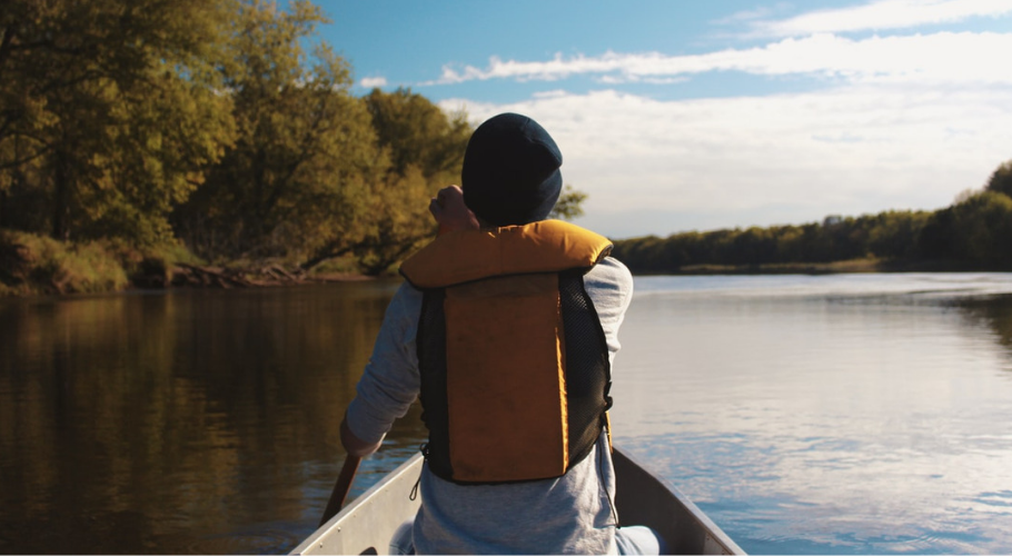 Man canoeing on lake