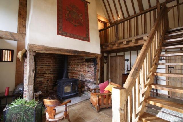The Main Barn hall area with woodburner